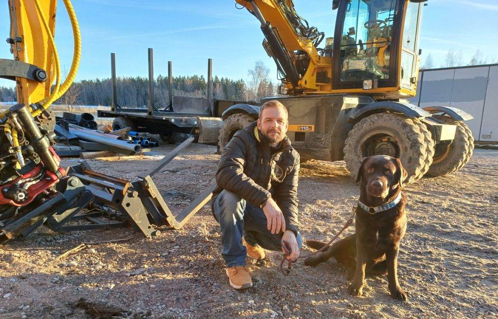 Mikko ja Paavo-koira kaivinkoneen edessä. Rakennus- ja maanrakennuspalvelut Fixmedi Oy Varsinais-Suomi
